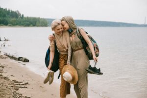 Same sex lesbian couple walking on the beach holding each other. Our couples therapist provides relationship therapy to all types, not just marriages. Learn more about how a St Pete marriage counselor can help today.