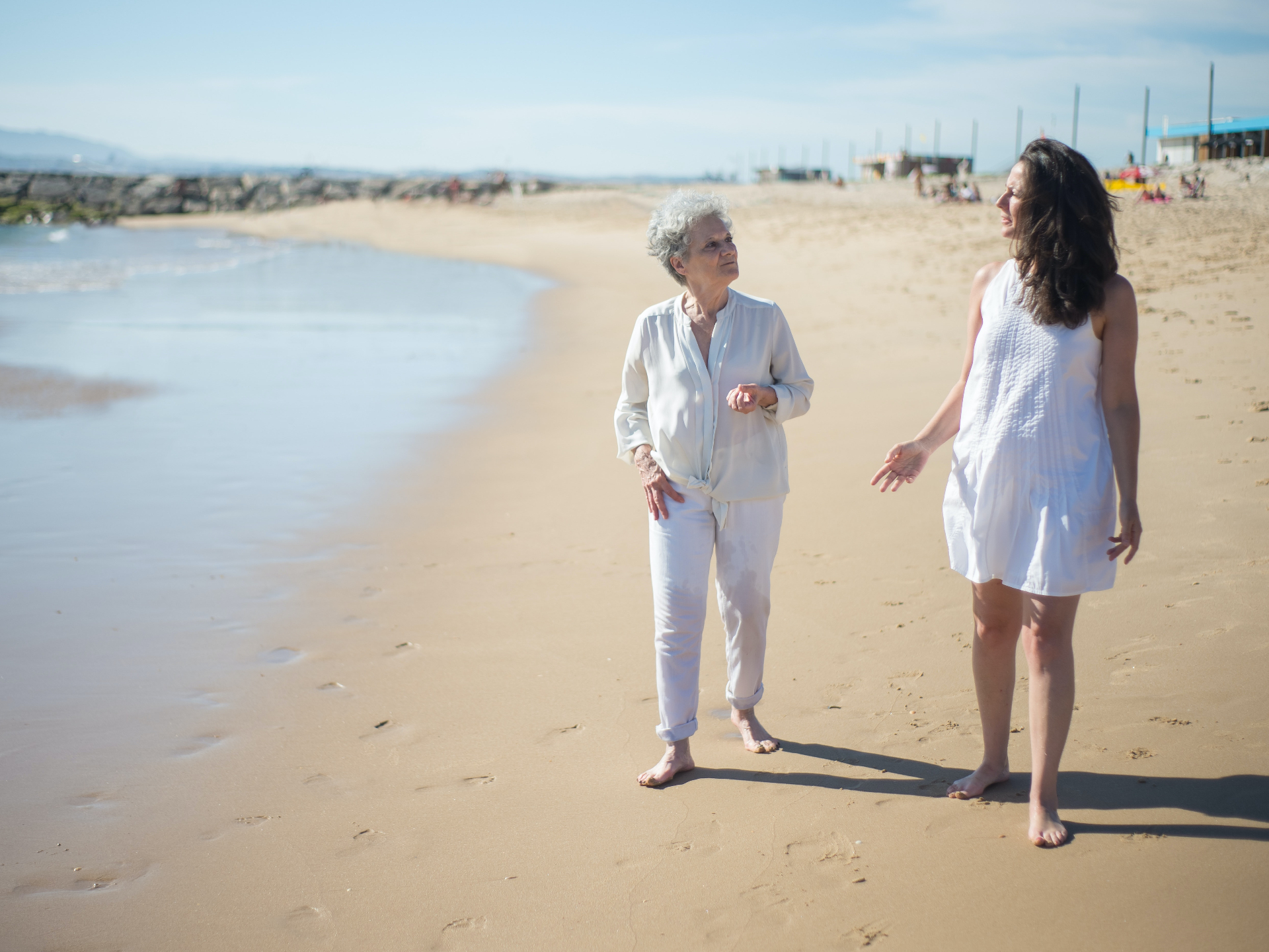 Image of an older and younger woman walking and talking on a sandy beach near the ocean. With the help of adult neuropsychological testing in Saint Petersburg, FL you can work through your memory issues and find your cognitive strengths.