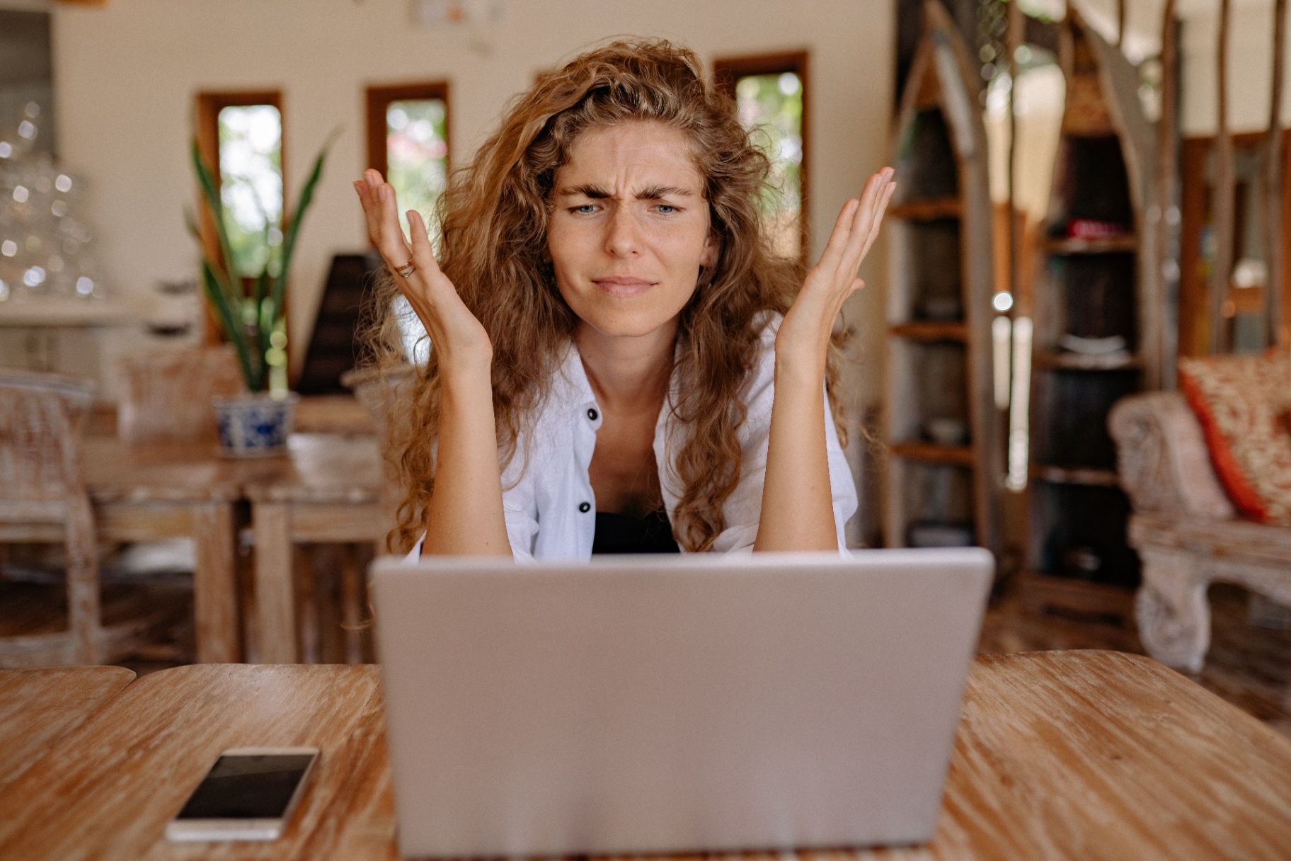 Image of women sitting at desk looking at her laptop and feeling frustrated at work. Begin coping with anxiety and stress with adult therapy in Saint Petersburg, FL.