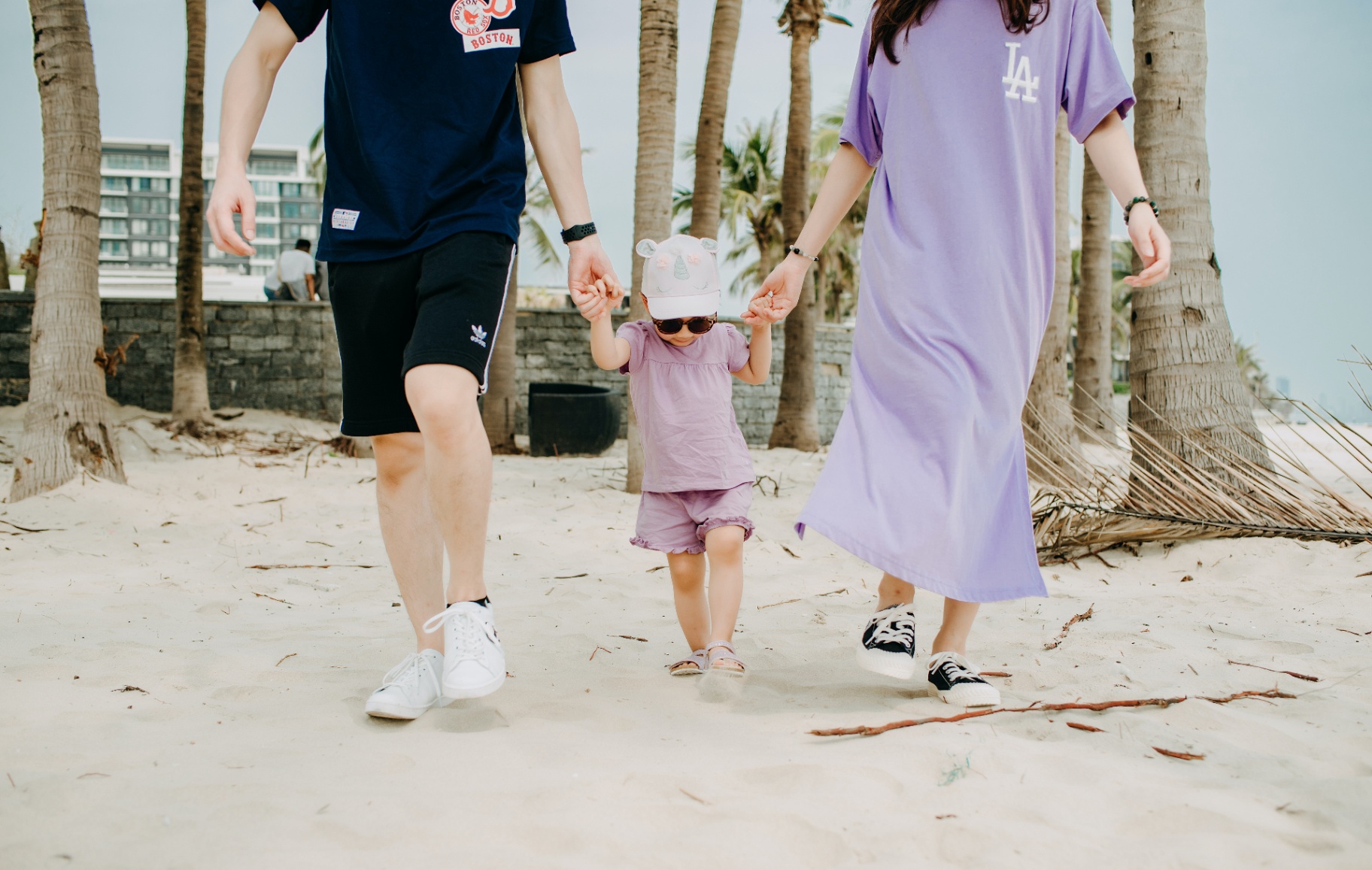 Young couple walking on beach holding the hand of their toddler daughter. Our St Pete, FL marriage therapist provides effective counseling for common couple's challenges including infidelity, trust, and communication. Learn more today.