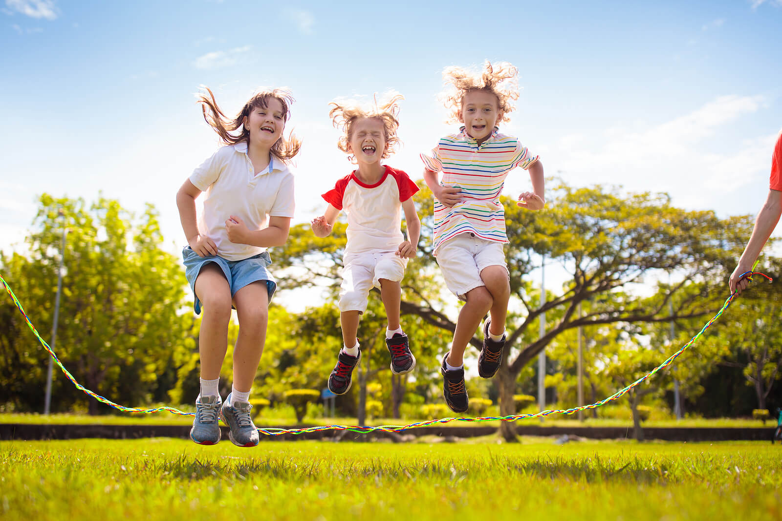 Image of three children happily jumping rope together outside. Does your child struggle academically? Learn how child neuropsych testing in Saint Petersburg, FL can help you support them.