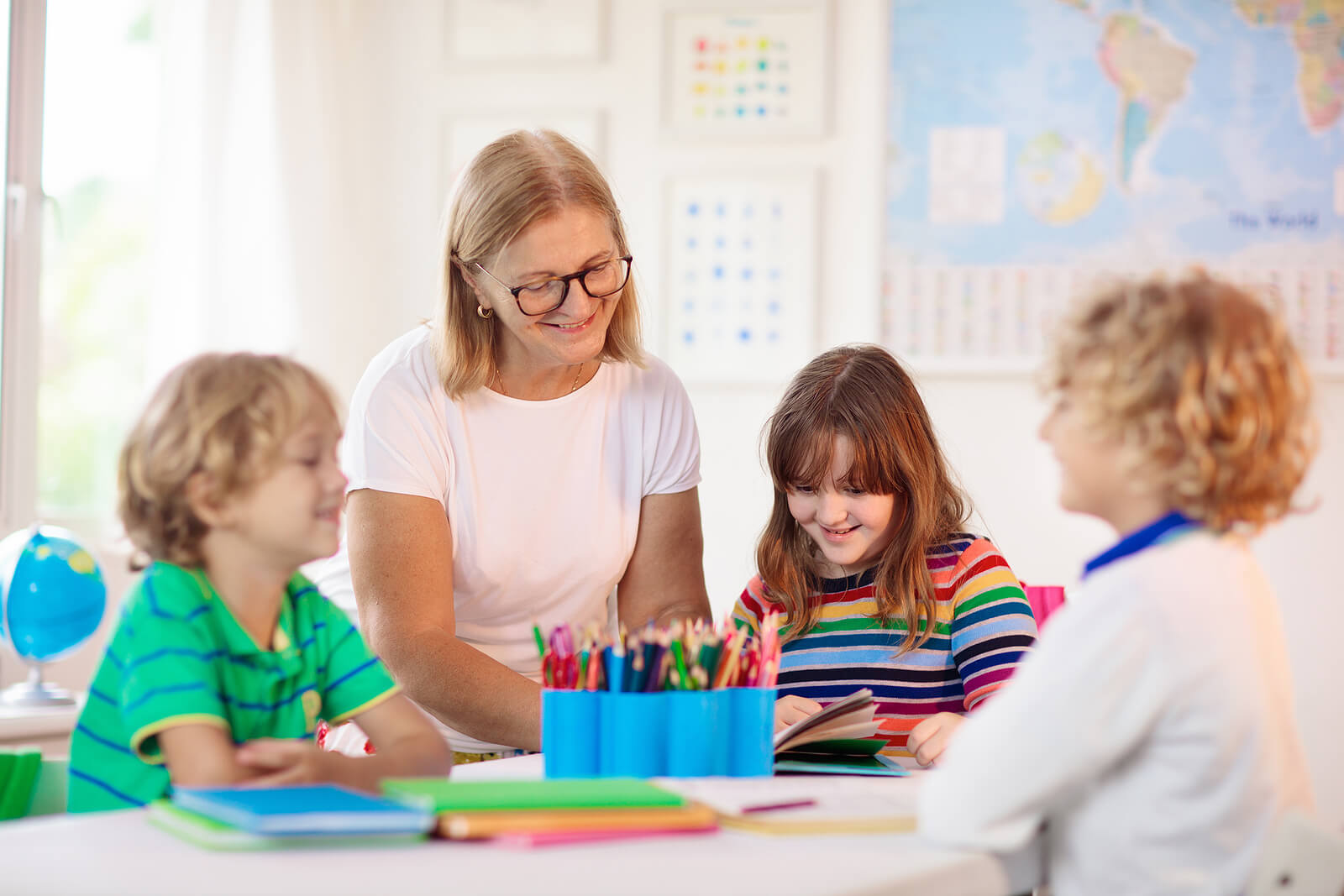 Image of a woman reading a book in a classroom to children. Does your child struggle academically? Learn how child neuropsych testing in Saint Petersburg, FL can help them find the support they need.