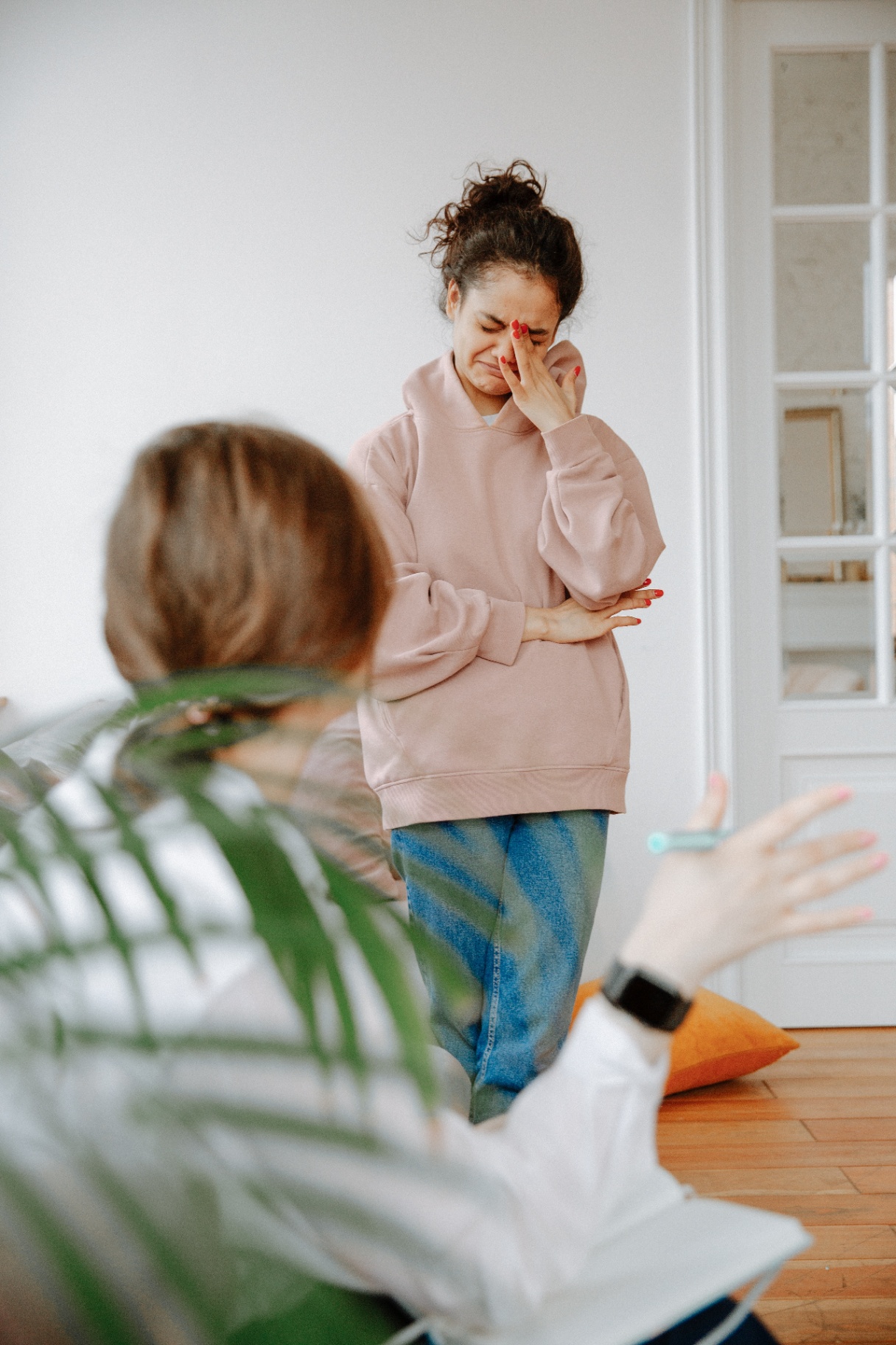 Image of a crying woman standing while another woman speaks to her. Anxiety symptoms can be difficult to overcome on your own. With the help of an experienced anxiety therapist you can begin working to manage them in a healthy way with anxiety therapy in Saint Petersburg, FL.