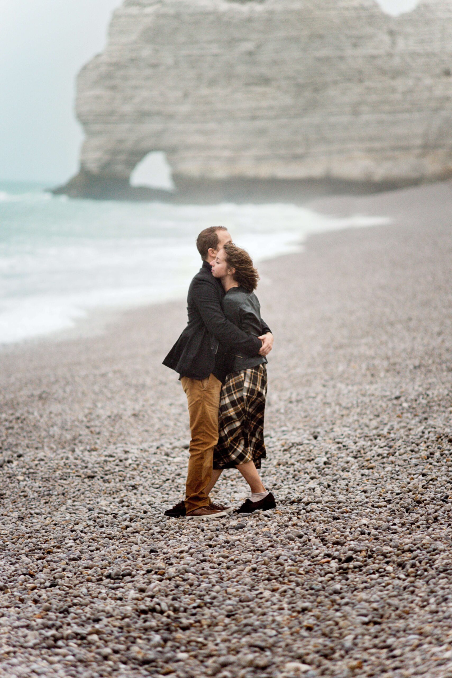 Image of a couple hugging and supporting each other while standing on a rocky beach on a cloudy day. Discover how Saible Neuropsychology can provide you support through trauma therapy and PTSD treatment in Saint Petersburg, FL and begin coping with your symptoms in healthy ways.