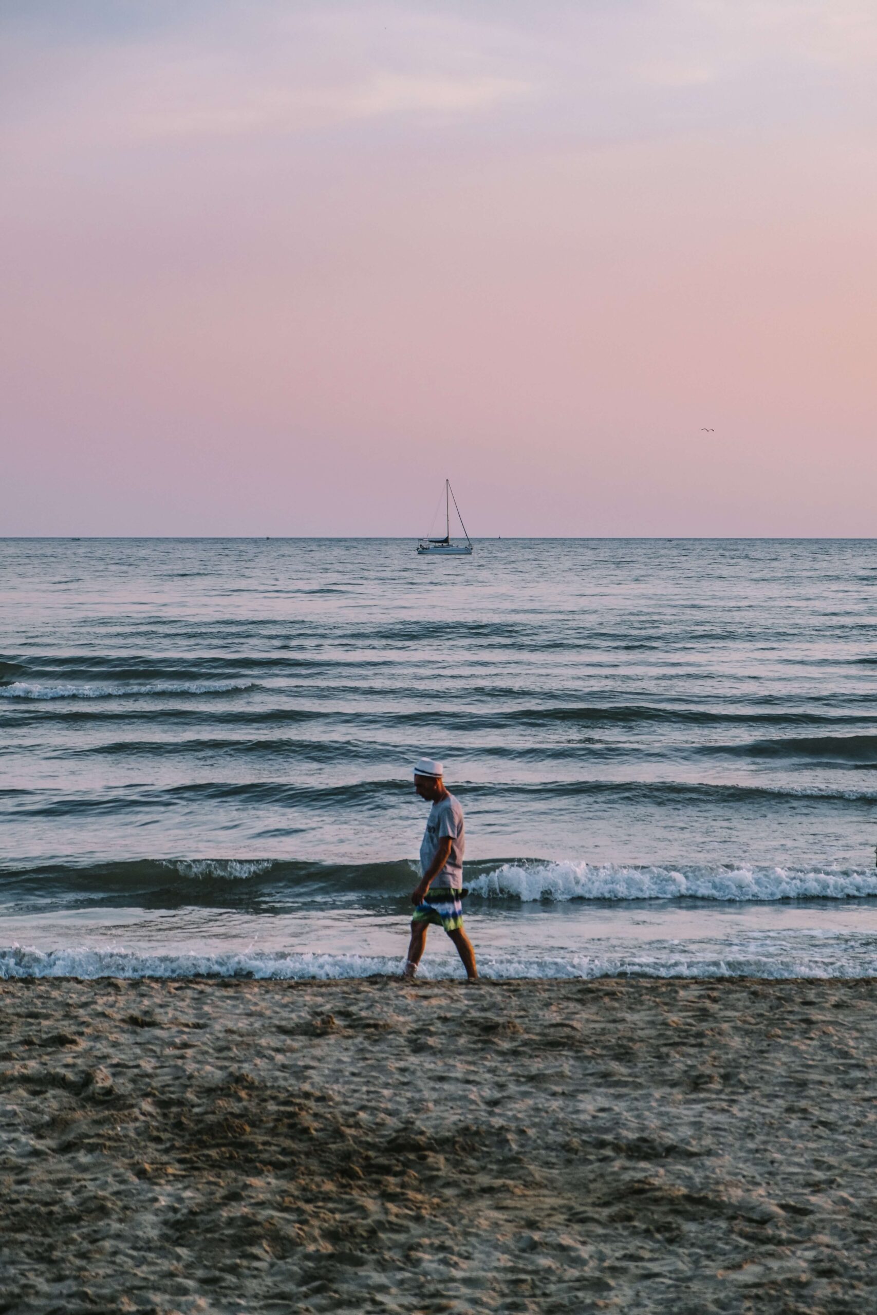 Image of a man walking on the beach during sunset. Struggling with your past trauma? Begin overcoming your trauma symptoms with the help of trauma therapy in Saint Petersburg, FL.