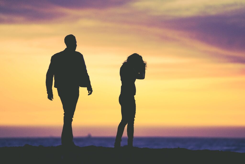 Wife walking away from husband on the beach. Trying to navigate the feelings that come with marriage separation? Our Saint Pete, FL therapists offer divorce recovery therapy to help you process and heal. 