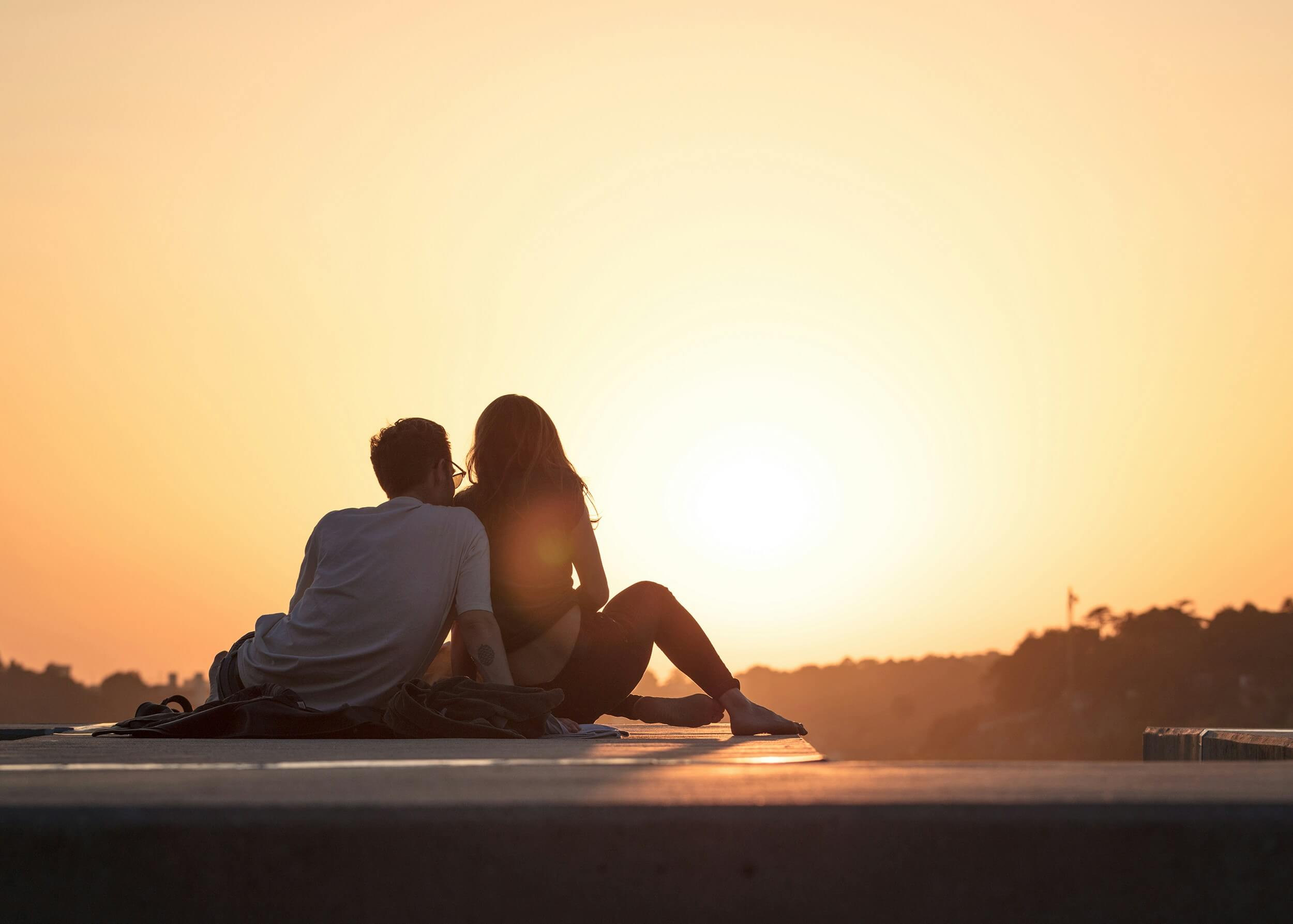 Couple sitting together watching the sunset. Are you wondering what the common challenges couples face? Our couples therapist in Saint Petersburg, FL can help your relationship with a range of struggles.